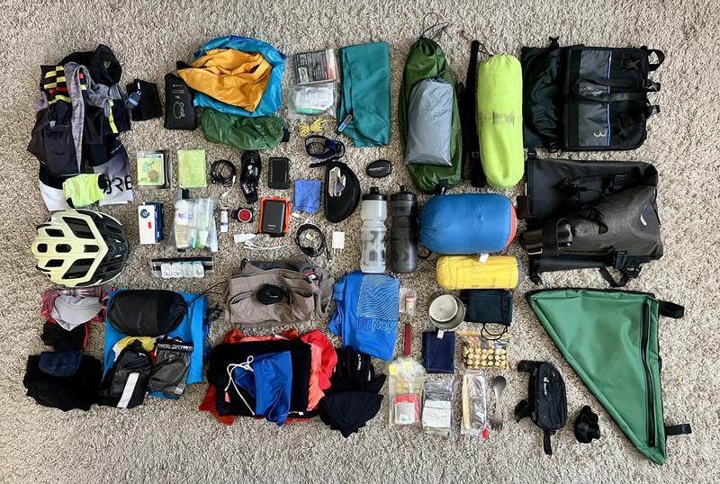 Bikepacking gear laid out on the floor